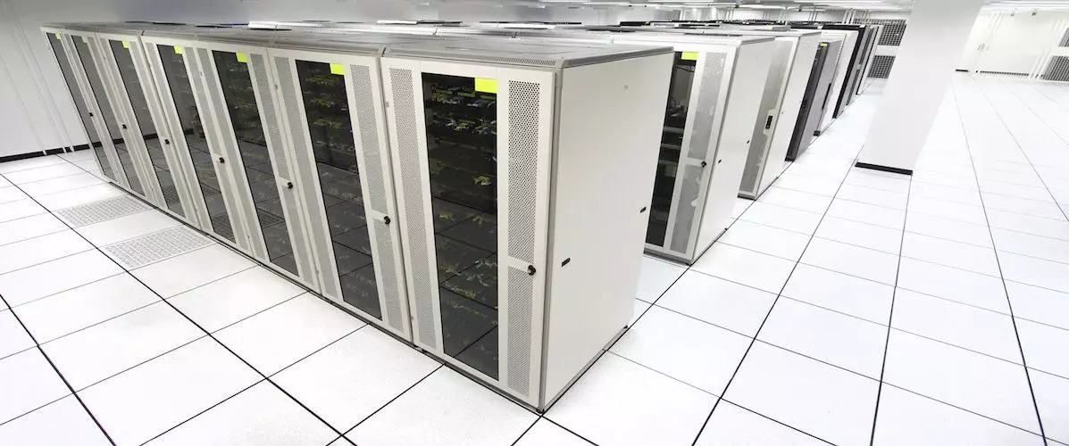 Modern computer room with raised access flooring, housing server racks and cable management systems – ideal for data centres, server rooms, and IT infrastructure environments